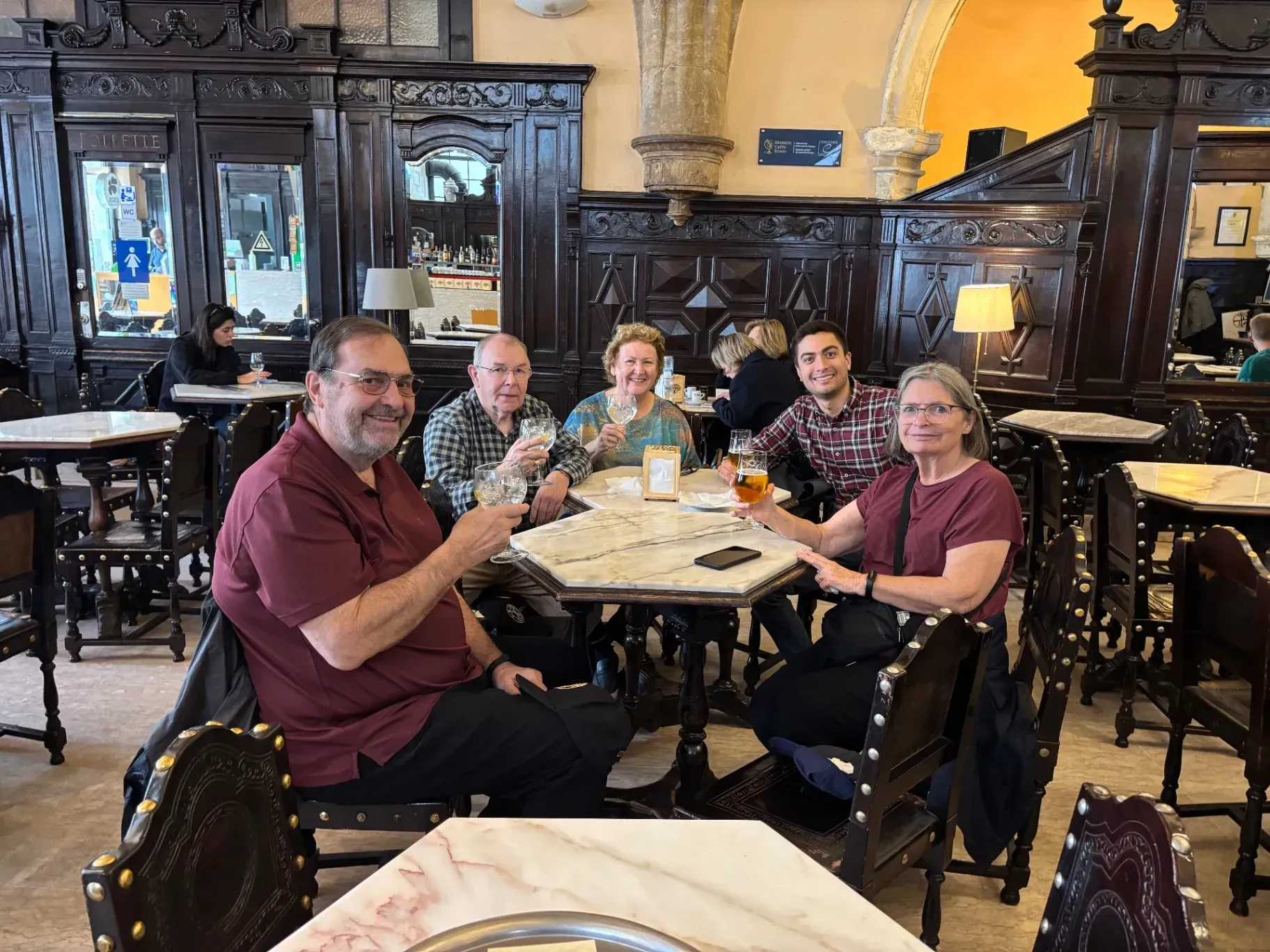 Mateus, local host of Coimbra Private Tours, with guests enjoying drinks at the historic Café Santa Cruz before the daily fado performance.