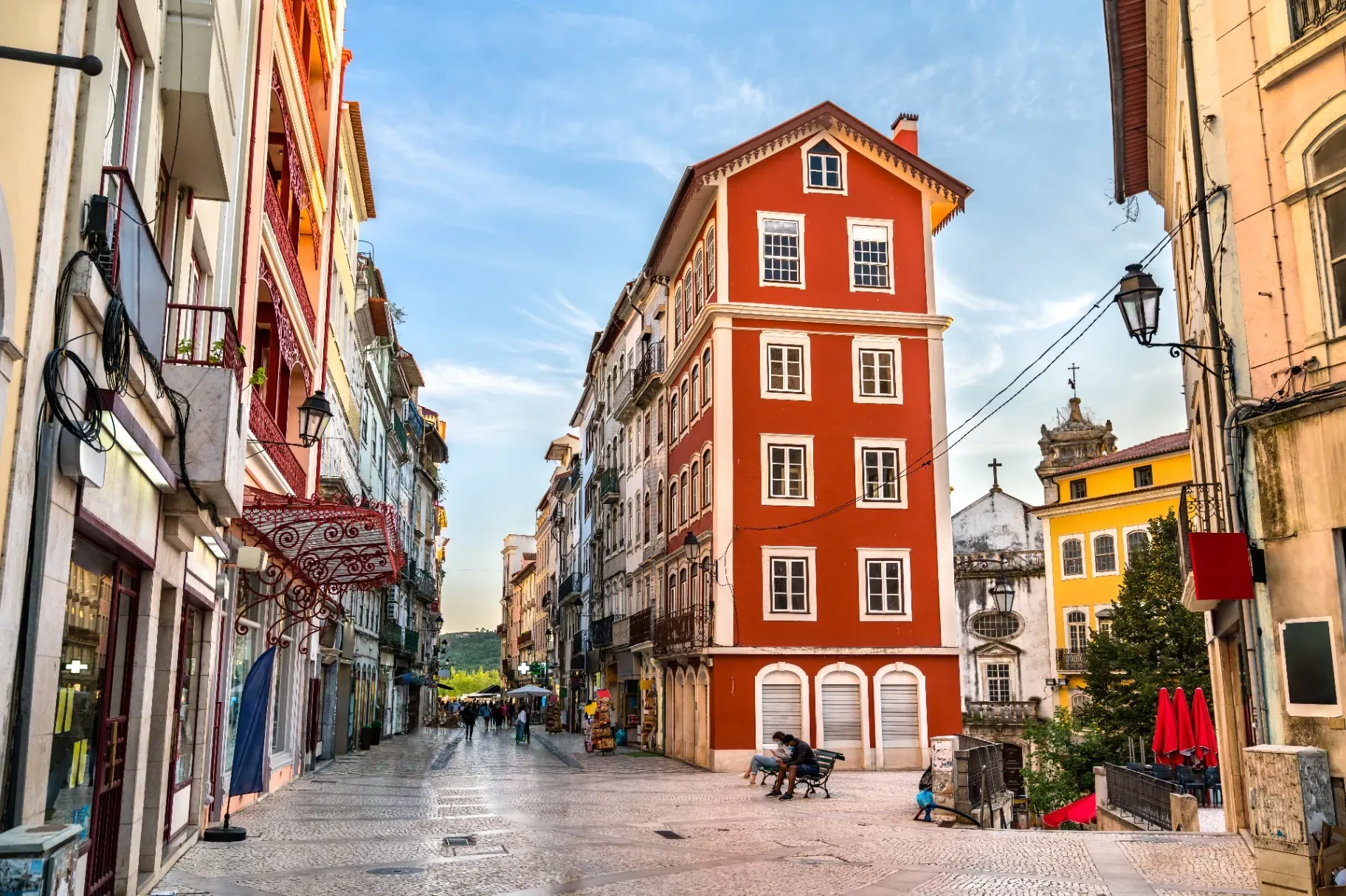 Rua Ferreira Borges pedestrian street with shops and people in Coimbra