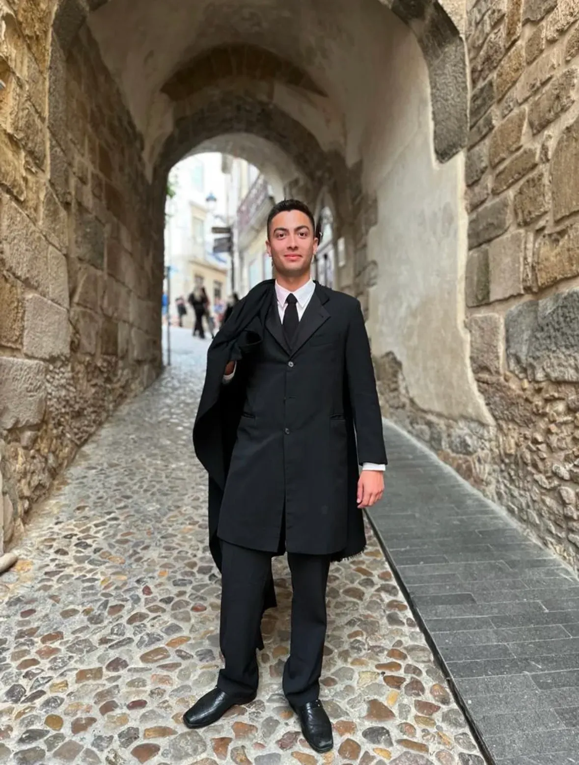 Mateus wearing traditional University of Coimbra academic uniform